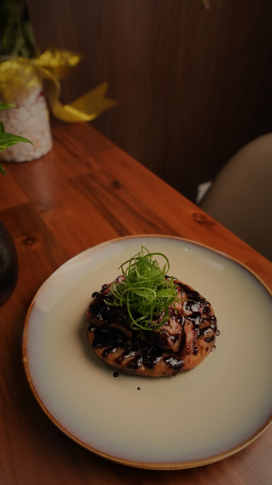 A plated dish on dark wood