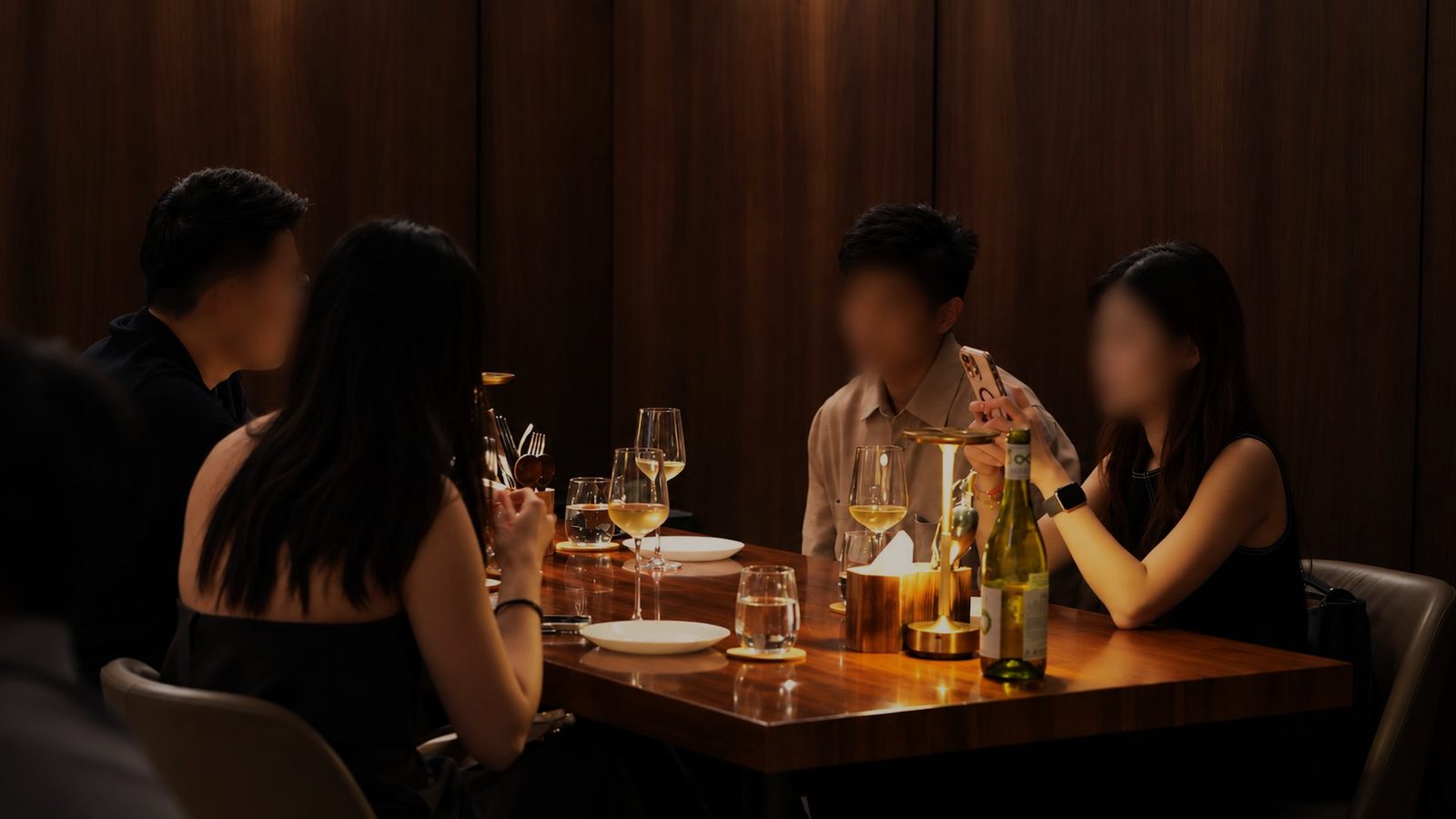 Guests at a table at Carbon, in warm evening light