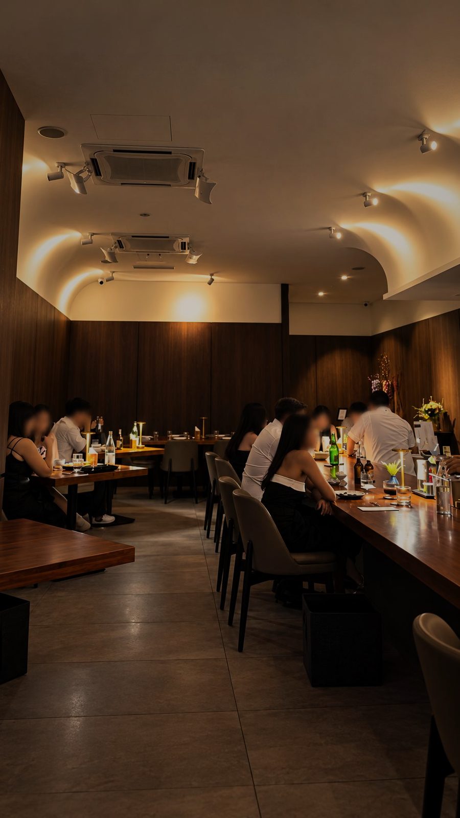 Guests dining along the timber wall