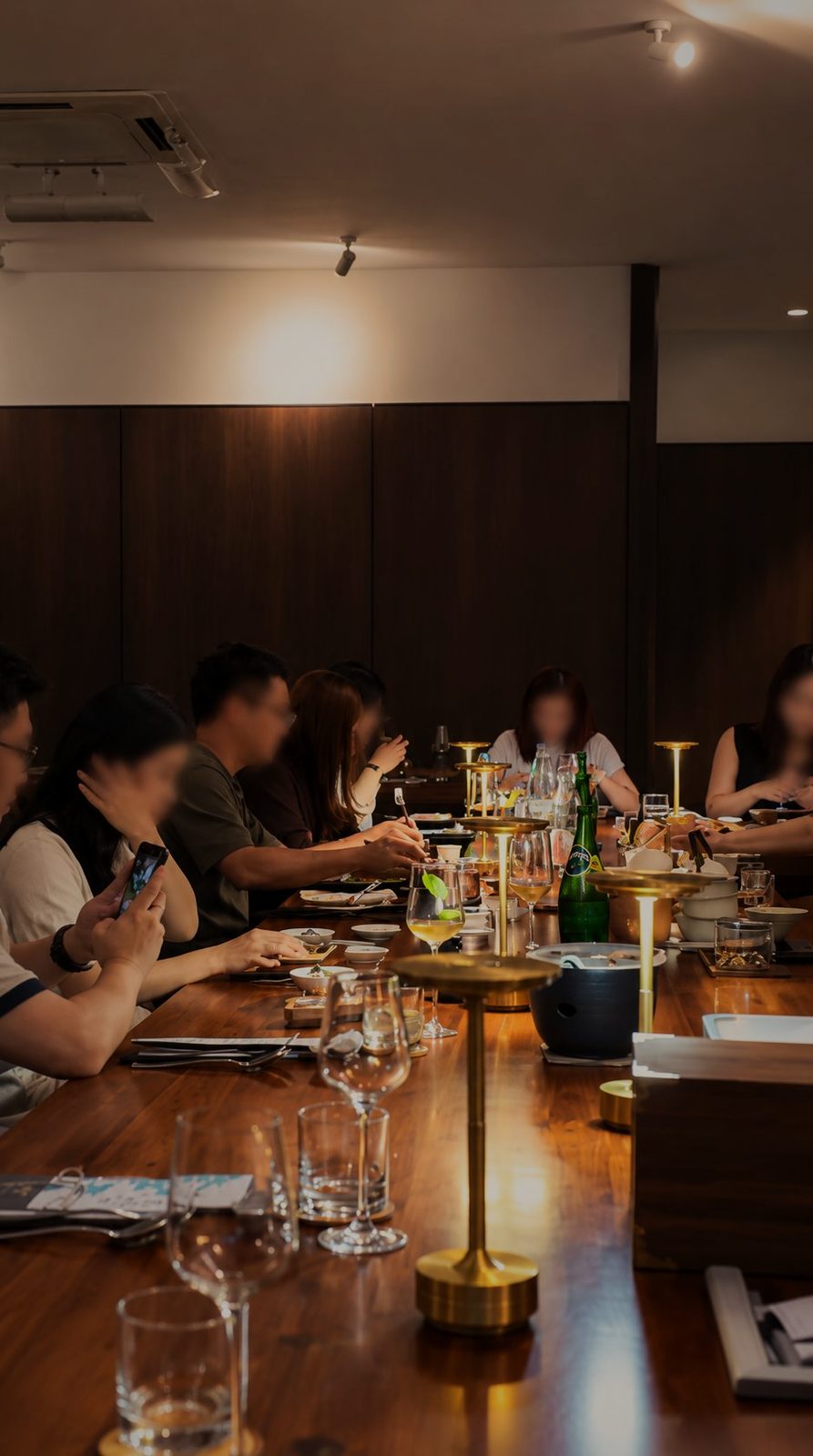 A table of guests under warm lights