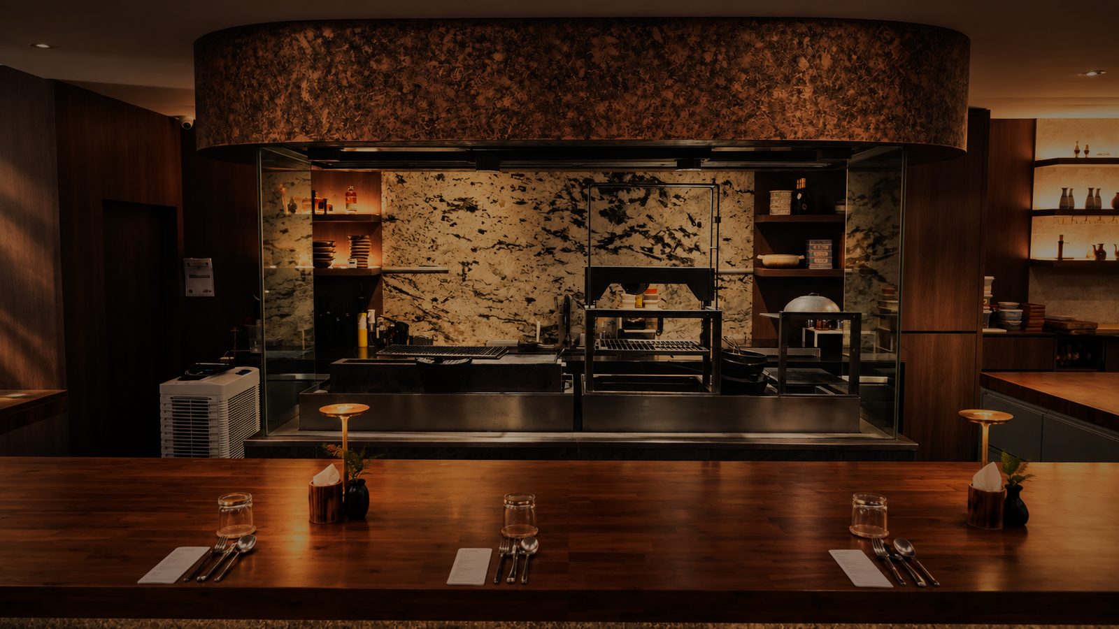 The open kitchen under its copper hood, seen across the counter
