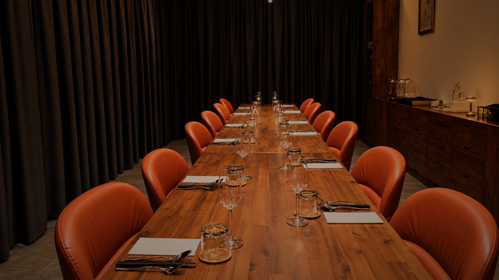 The private dining table set for a party, in warm light